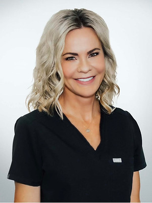 Portrait of Summer Faulkner, a smiling woman with shoulder-length blonde hair, wearing a black top.